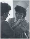 Student Nurse C. Jakala with a Patient, 1983 by Advocate Aurora Health