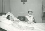 Nurse reading to patient by Aurora Health Care